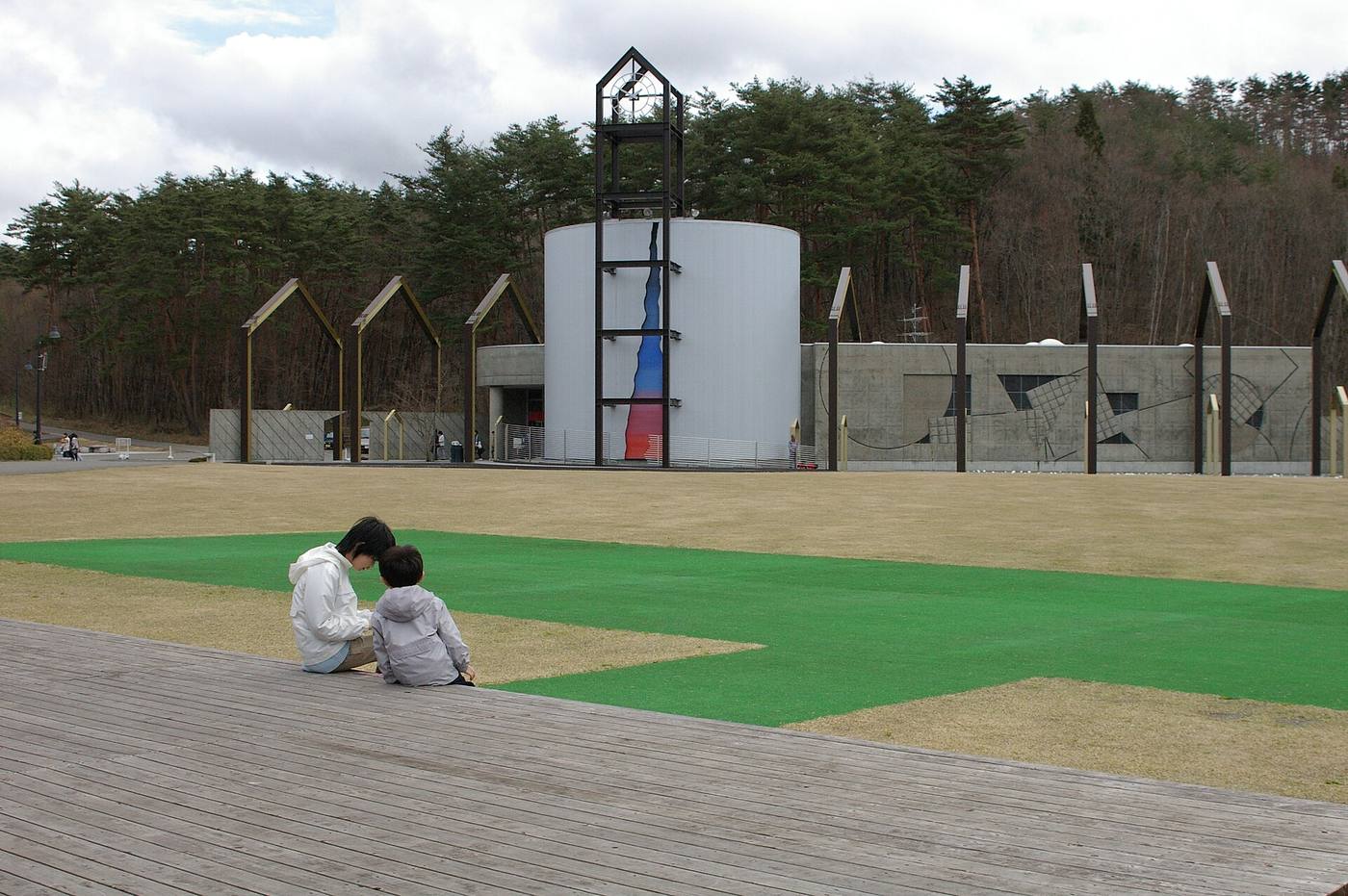 The outdoor entrance structures and open lawn at Miyazawa Kenji Dowa Mura.